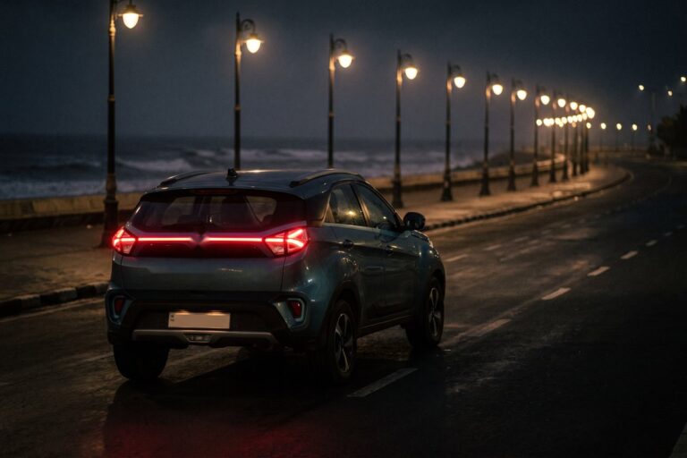 Compact electric SUV on a seafront road at night