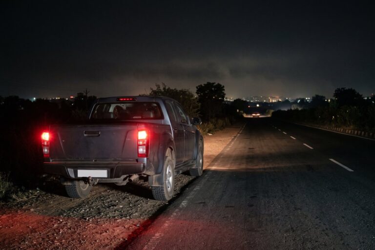 Pickup on the shoulder of an empty highway at night